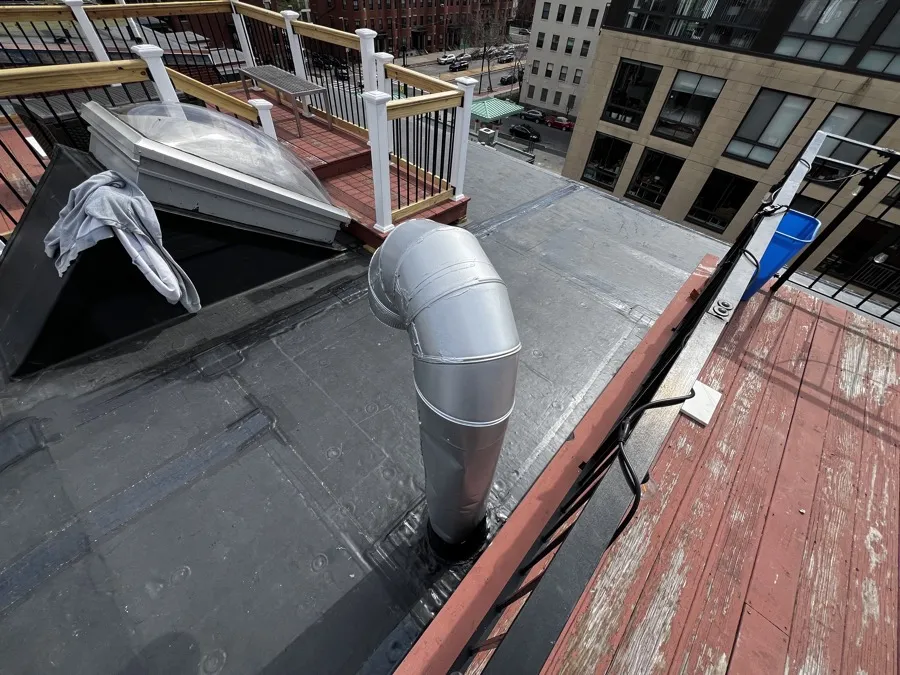 Rooftop skylight and vent pipe detail on a flat commercial roof