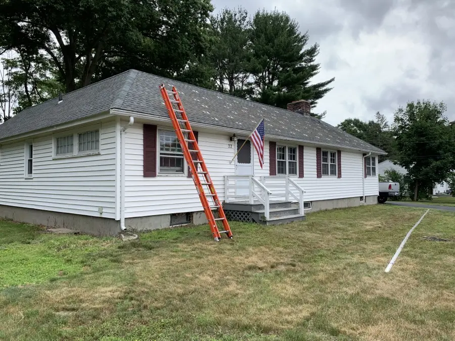 Ranch-style home with a ladder set up for roof work