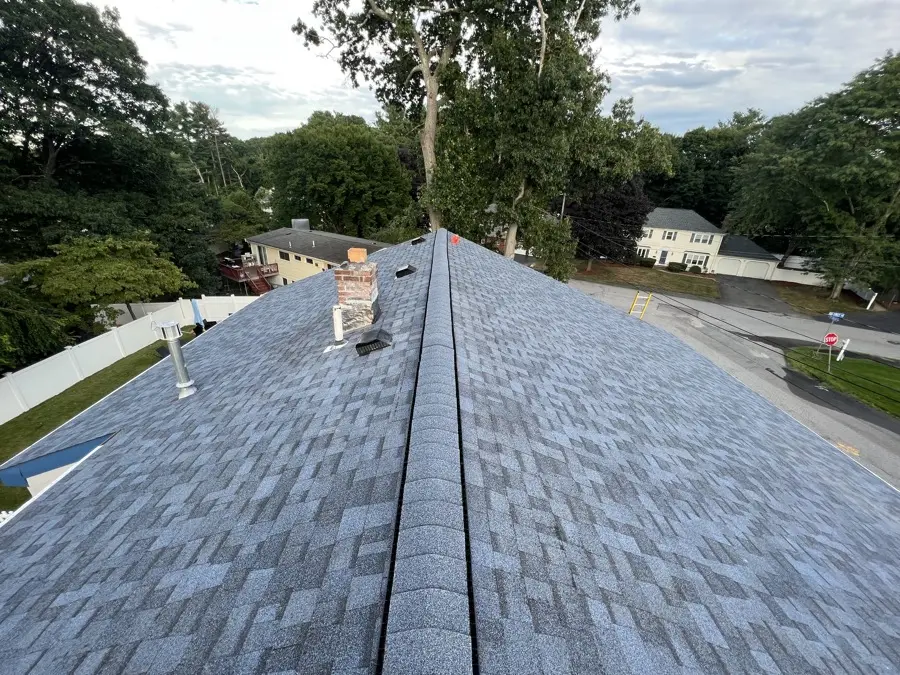 Freshly installed dimensional asphalt shingle roof ridge